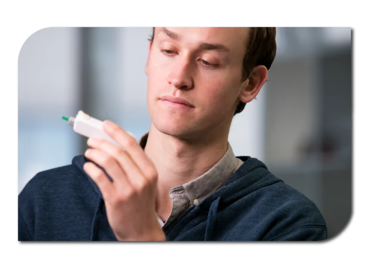 A man holding a white plastic medical diagnostic device