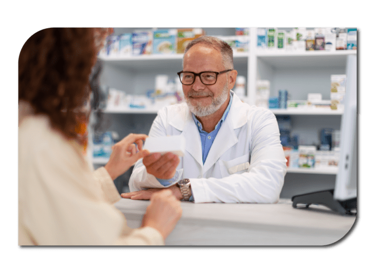 A pharmacist and patient discussing medications in a pharmacy
