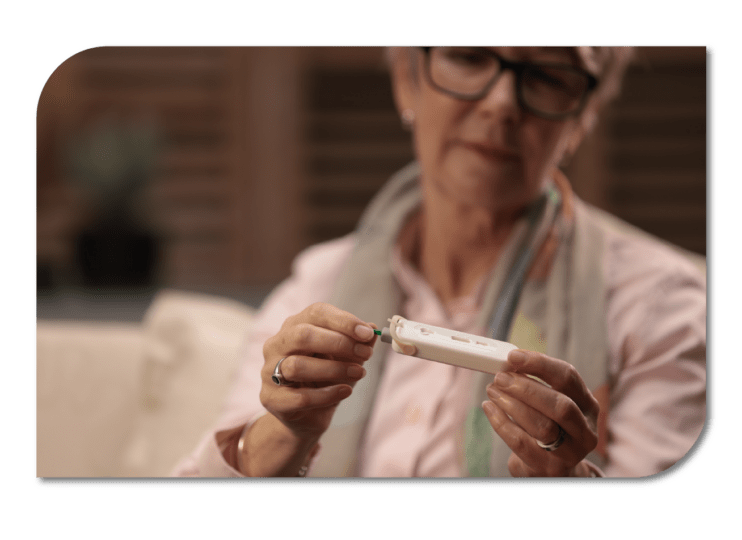 A woman holding a medical diagnostic device, ready to perform a test