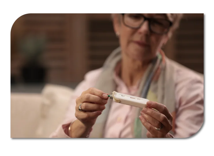 A woman holding a medical diagnostic device, ready to perform a test